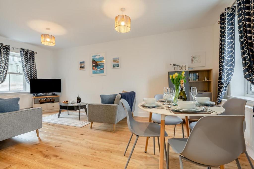 a dining room and living room with a table and chairs at 2 Bed in Bude oc-u31759 in Bude