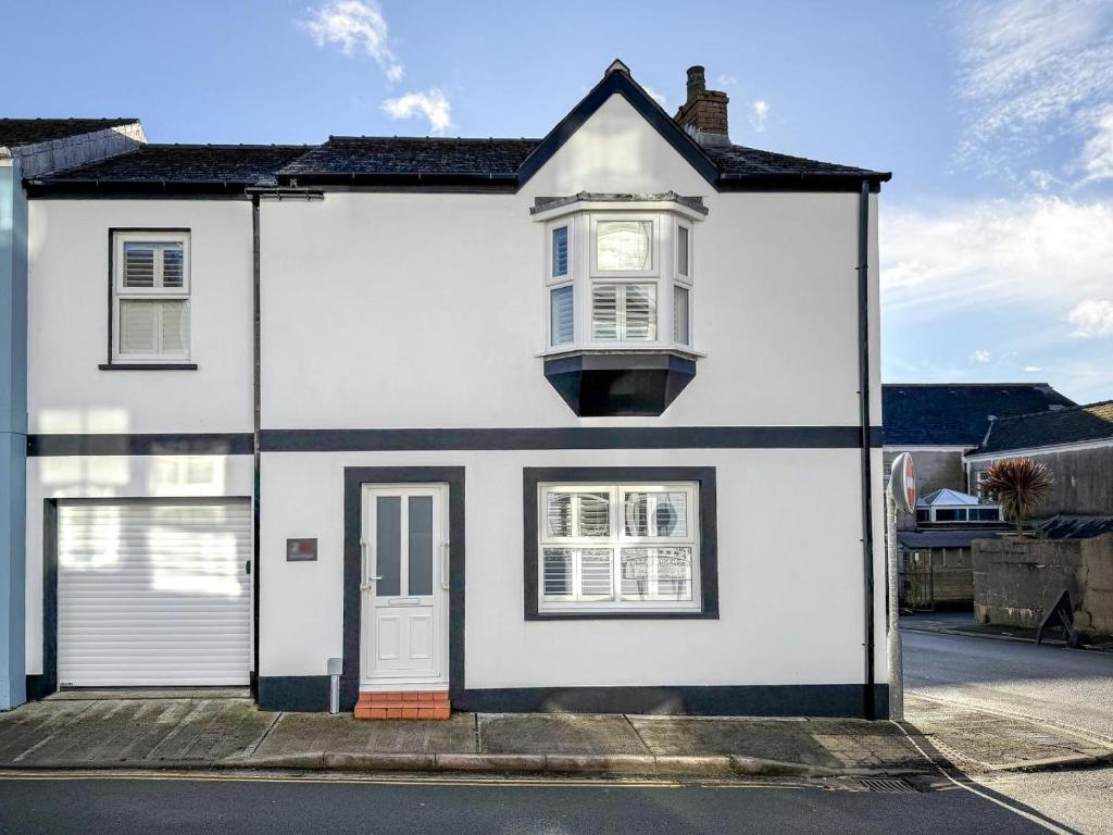 a white house with a window and a door at 3 Bed in Tenby oc-m29588 in Tenby