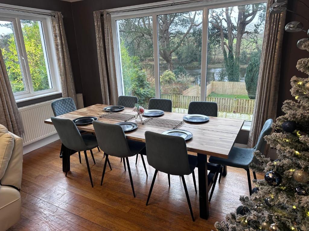 a dining room table with chairs and a christmas tree at Greenways House in Lancaster