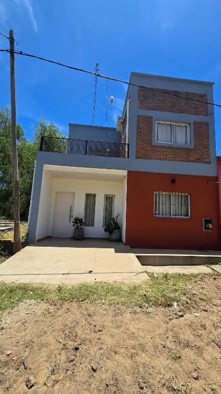 a red and white house with aventh floor at Casa 12o - Paso de la Patria in Paso de la Patria