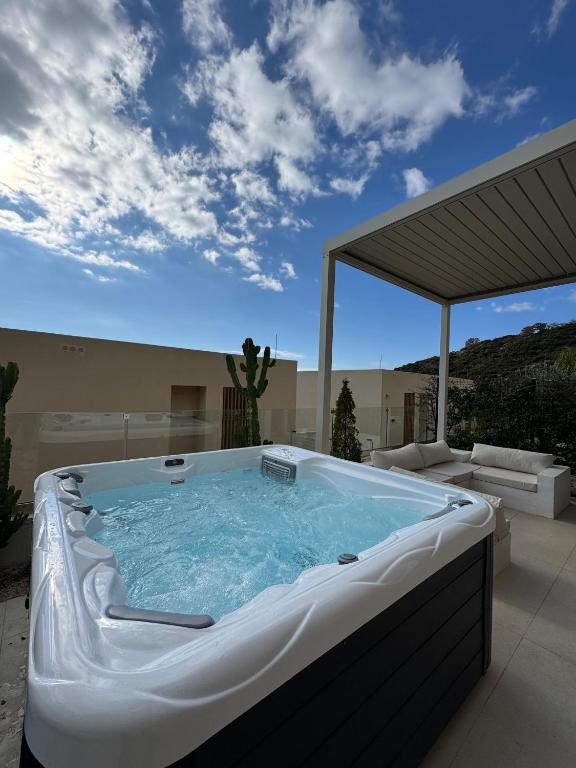 a hot tub sitting on a patio with avisor at Aquaterra, Green Coast in Palasë