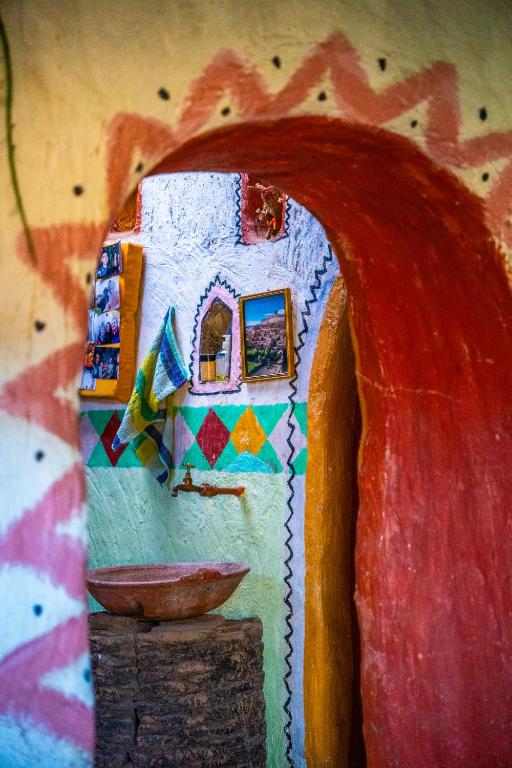 a model of a house with a bowl on a wall at Traditional Berber Eco Farm Stay in Agadir
