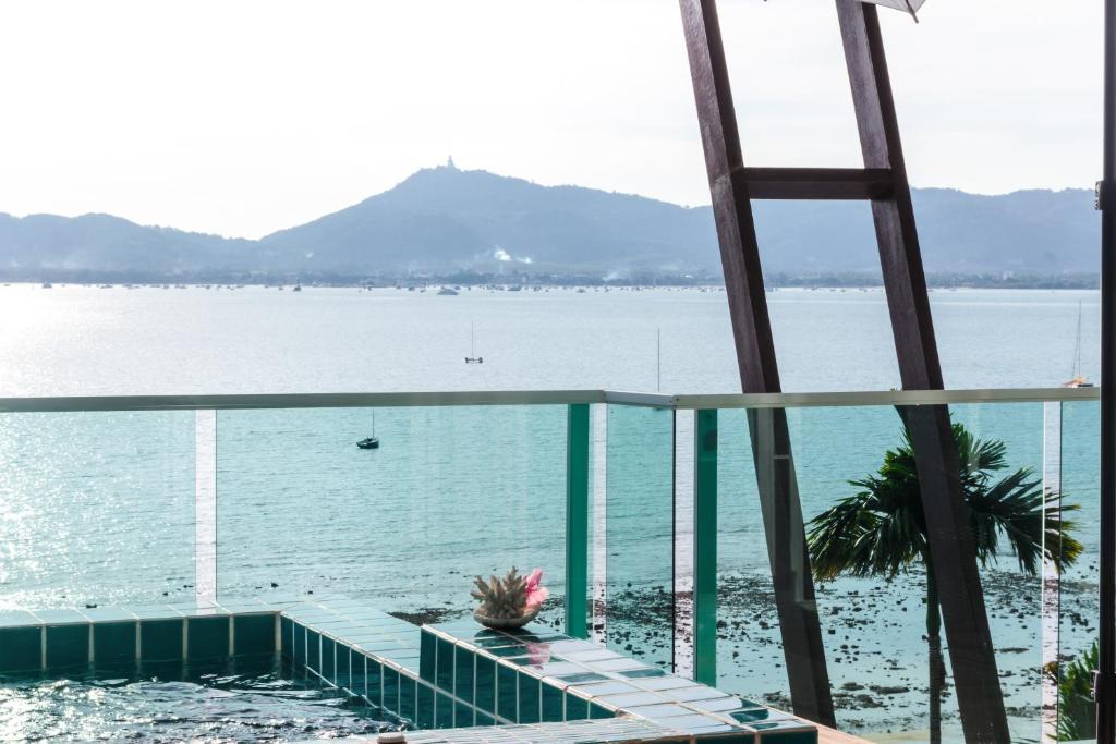 a view of the water from the balcony of a building at Davina Beach Homes in Panwa Beach