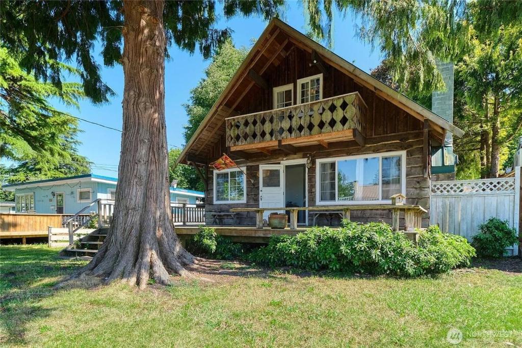 a house with a tree in front of it at Charming and cozy cottage at Maple Beach in Point Roberts