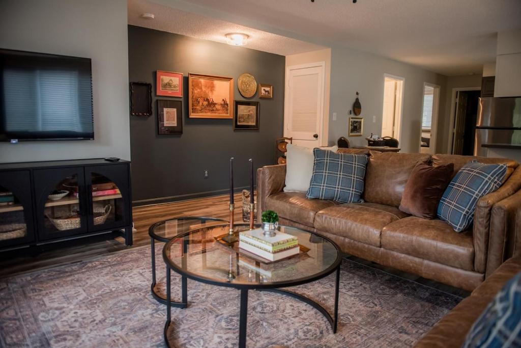 a living room with a couch and a coffee table at The Fox Hunt - A Ground Floor Condo in Southern Pines