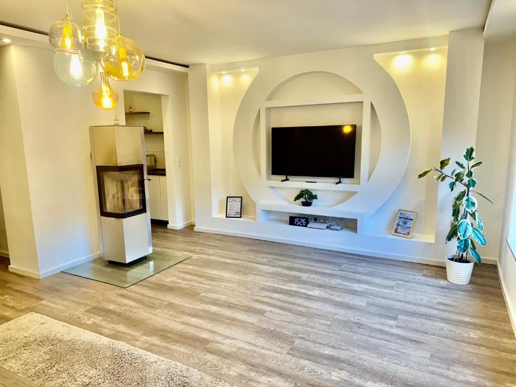 a large living room with a television and a fireplace at Im Point von Kiel City in Kiel