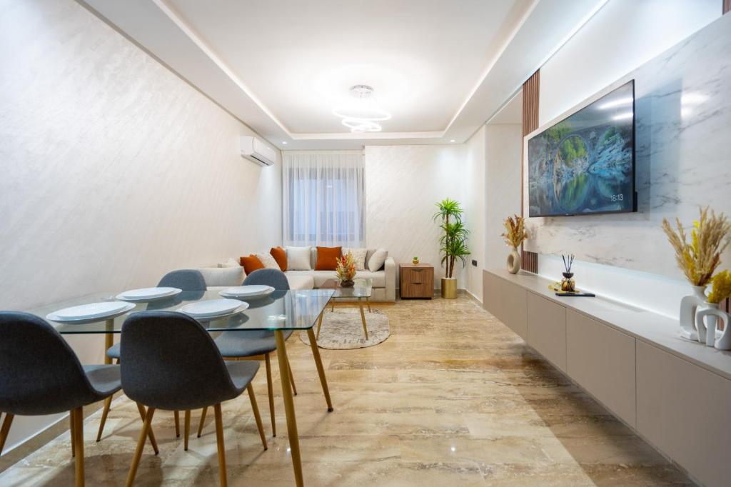a living room with a table and chairs and a couch at Magnificent apartment 10 in Casablanca