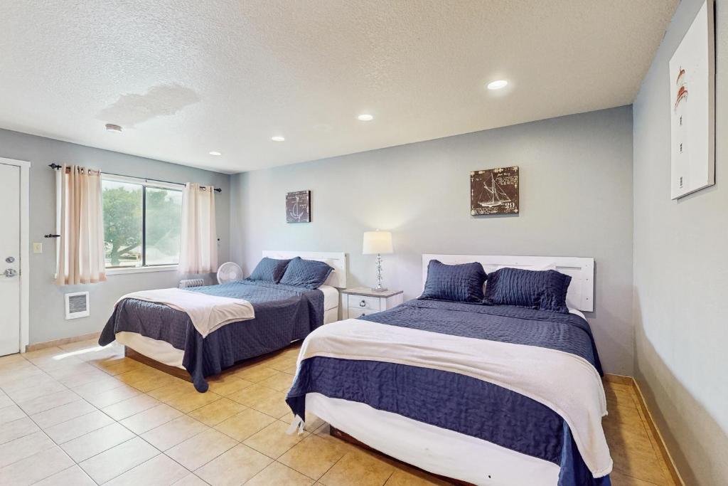 a bedroom with two beds and a window at Sea Treasures Inn #102 in Rockaway Beach