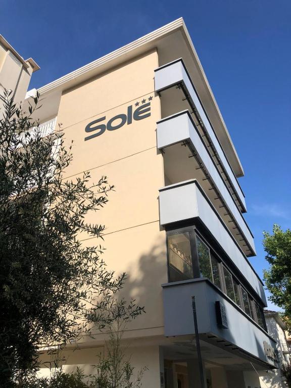 a building with the sider sign on the side of it at Hotel Sole in Cattolica