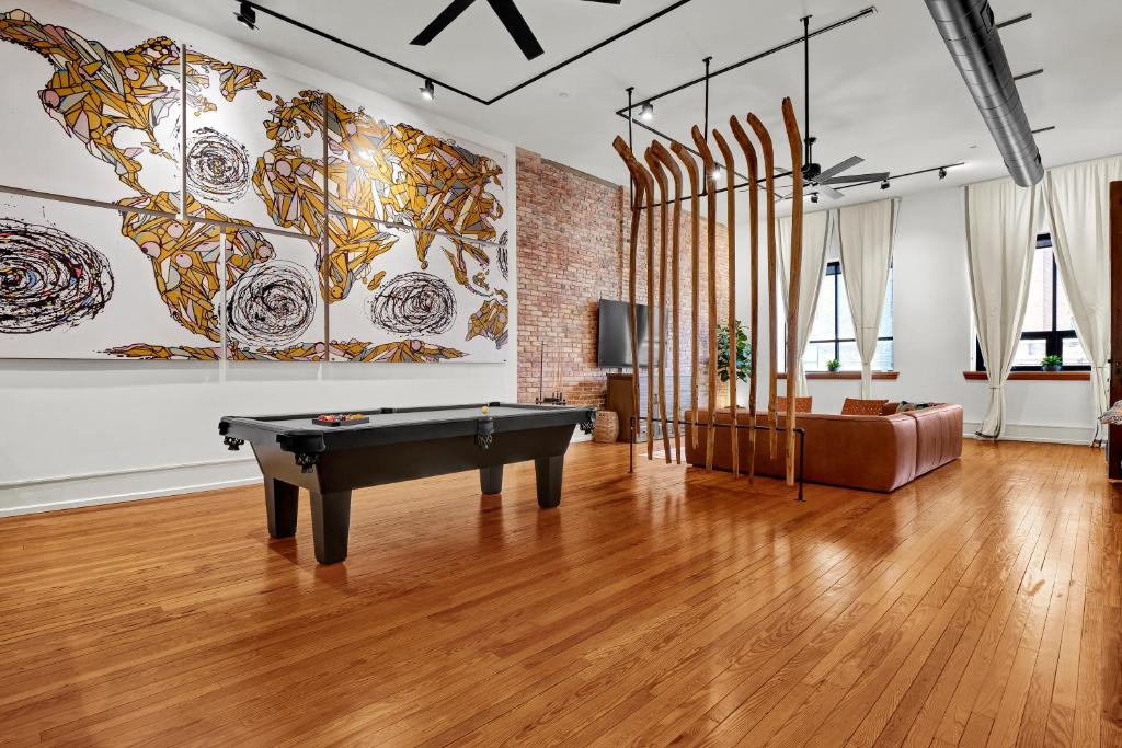 a living room with a pool table and a couch at Luxe 220 Suite 6 in Wilmington