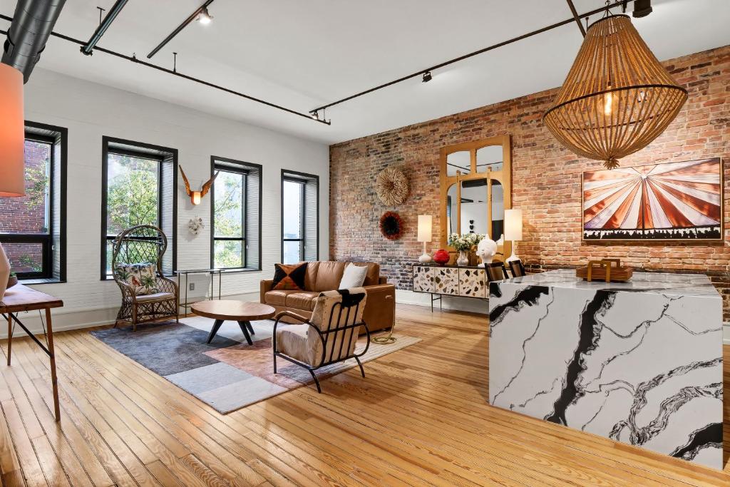 an open living room with a brick wall at Luxe 220 Suite 7 - Entire in Wilmington