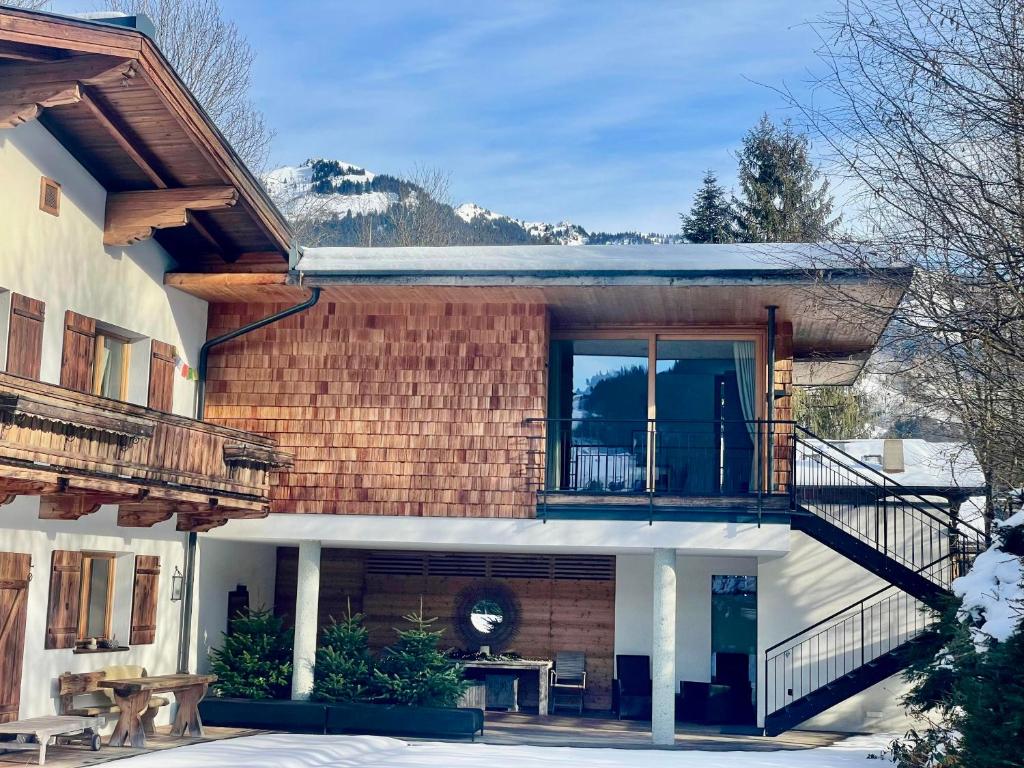 a house with a balcony and a patio at Winklern Lodges in Kitzbühel