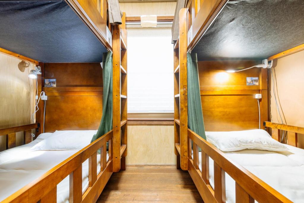 Postel nebo postele na pokoji v ubytování Guest House Enishi