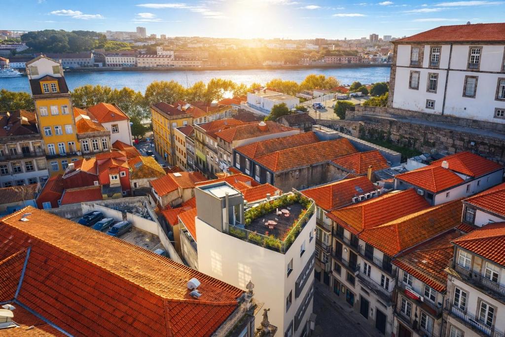 an aerial view of a city with orange roofs at Oporto Riverside Rooftop in Porto