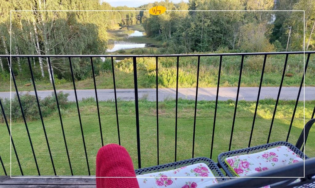 a person with their feet up on a balcony at Woxy Prilutta in Voxnabruk