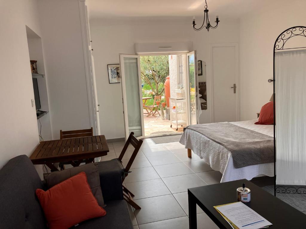 a living room with a bed and a couch at Studio Mas Pierre in Maureillas