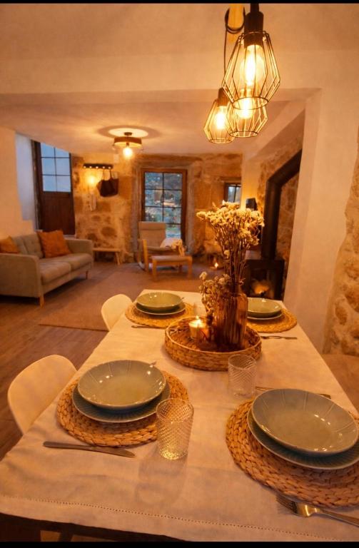a table with plates on it in a living room at Casa Martinho & Neves in Seia