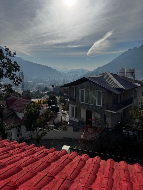 a view from the roof of a house with red roofs at Peaceful Mountain Cottage in Bhīm Tāl
