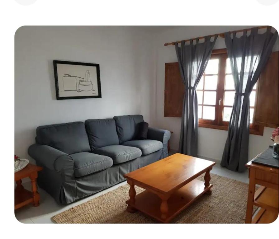 a living room with a couch and a coffee table at Apartamentos Punta Mujeres alto derecha in Punta Mujeres