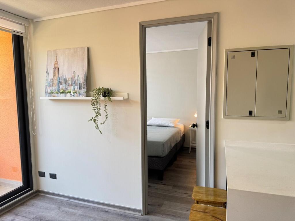 a room with a door leading to a bedroom at Muelle Barón - Terminal de Buses in Valparaíso