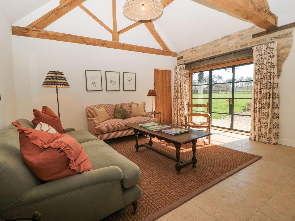a living room with a couch and a table at The Forge in Stow on the Wold