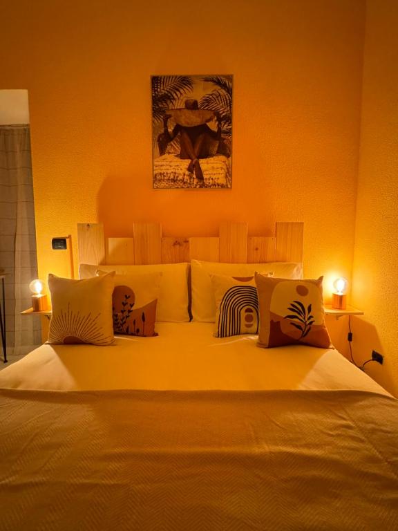 a bedroom with a large white bed with pillows at Il Gelso Bianco in Bordighera