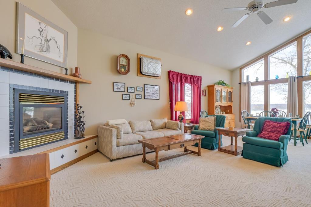 a living room with a couch and a fireplace at Lake Access w/ Dock! Hayward Cabin Hideaway in Hayward