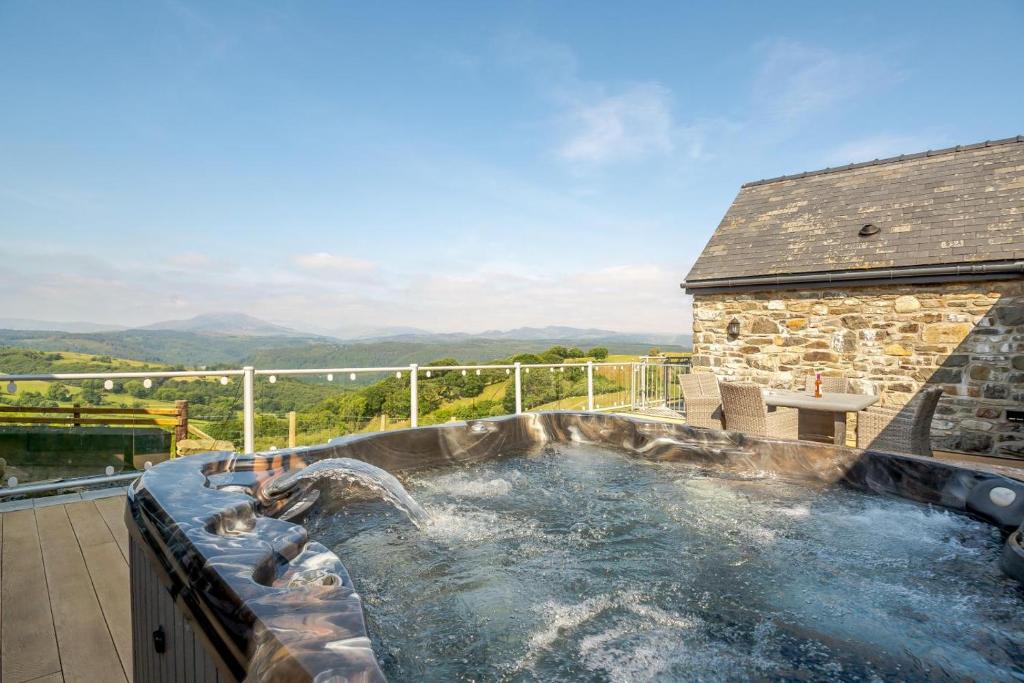 a hot tub on top of a patio with at 3 Bed in Llanrwst oc-bow155 in Llanrwst