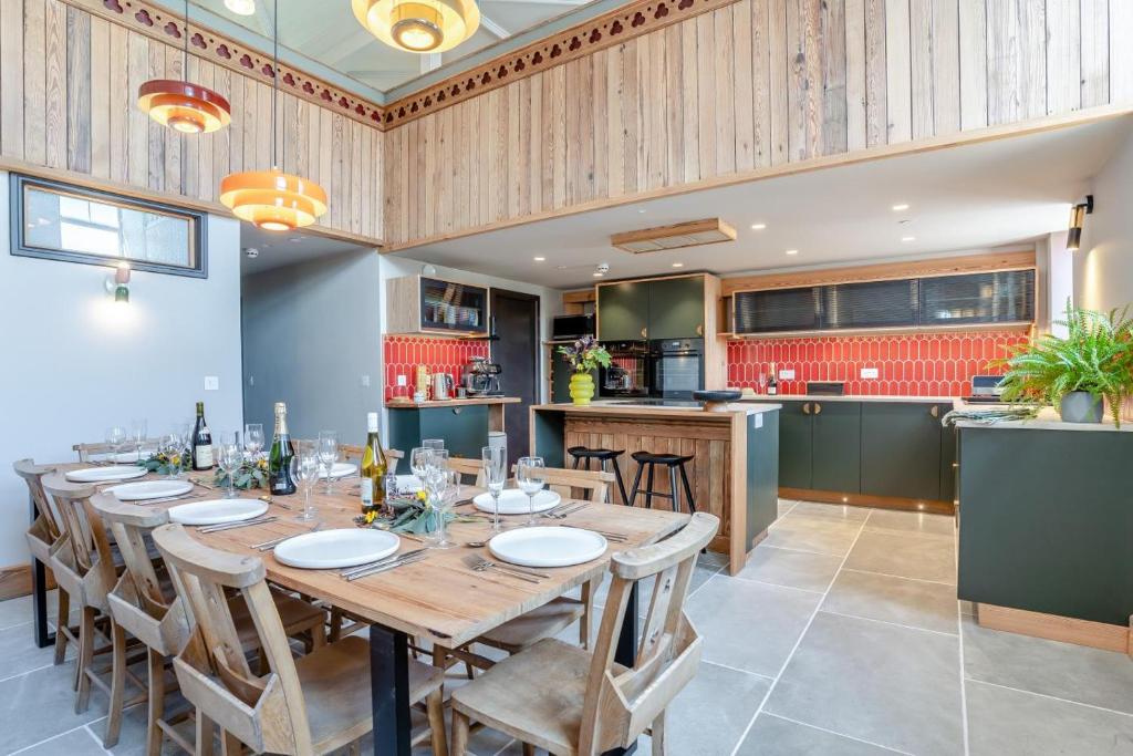 a dining room with a long table and a kitchen at 5 Bed in Bwlch oc-p32273 in Bwlch