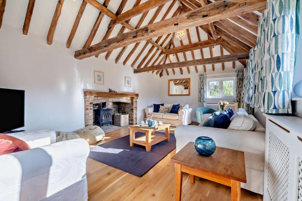 a living room with white furniture and a fireplace at 4 Bed in Flimwell oc-g30190 in Ticehurst