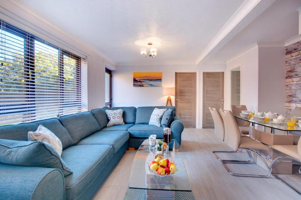 a living room with a blue couch and a table at 3 Bed in Cromer oc-2097 in Cromer