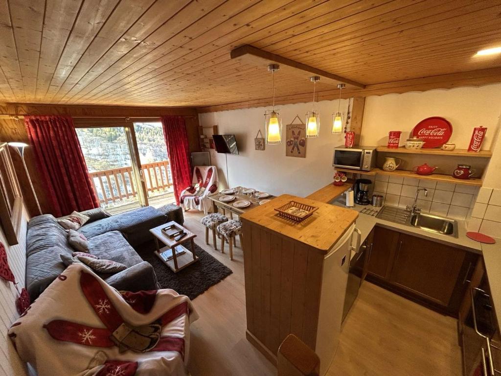 a kitchen and a living room with a couch and a table at Appartement 3 pièces, 6 pers, proche pistes, parking - FR-1-180-365 in Les Allues