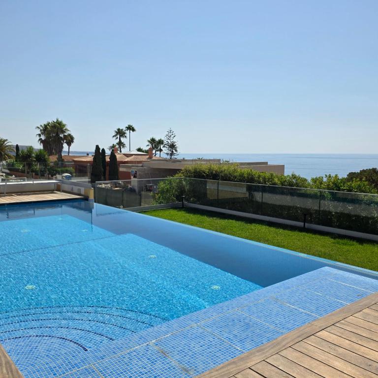 a swimming pool with a view of the ocean at Casa Azul in Luz