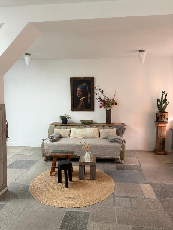 a living room with a couch and a table at Pothuis Zuid in Zandvoort