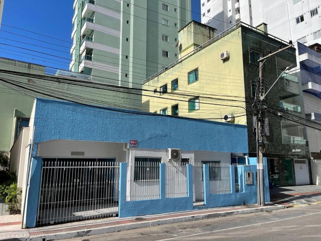 a blue building on the side of a street at Sol e Mar BC in Balneário Camboriú