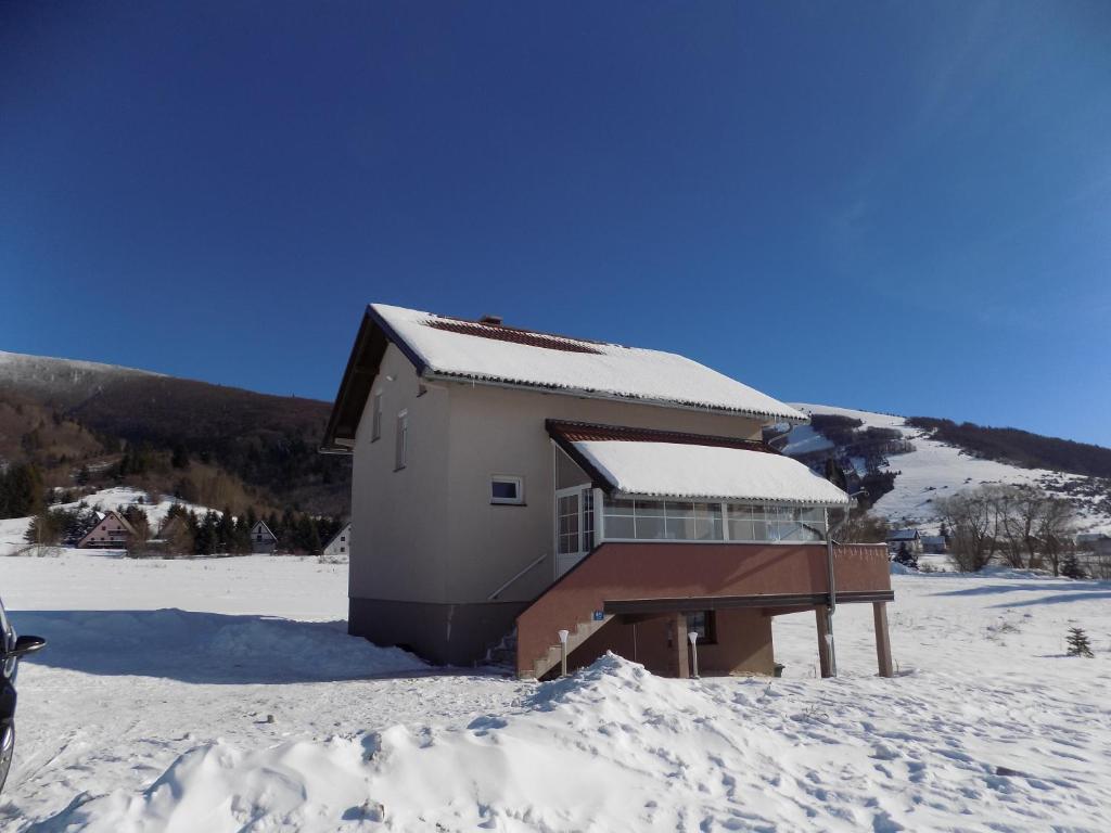 a building in the snow with snow on the ground at Kuća za odmor -Megy- in Kupres