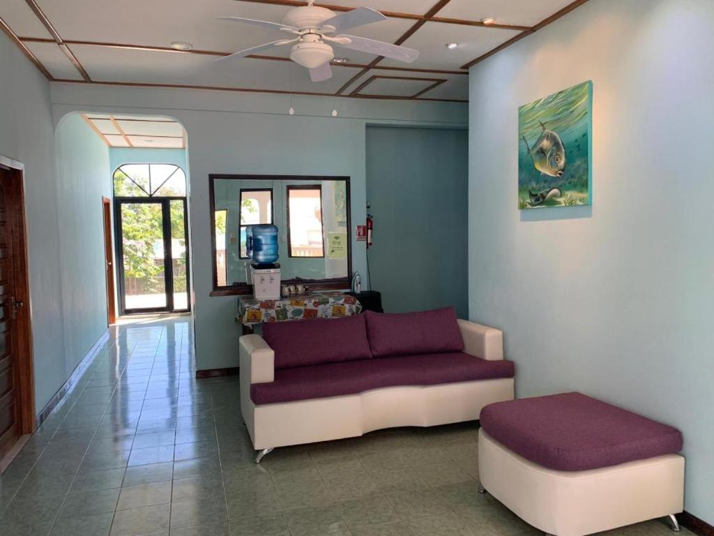 a living room with a couch and a table at Fernando'S Seaside Guest House in Sarteneja