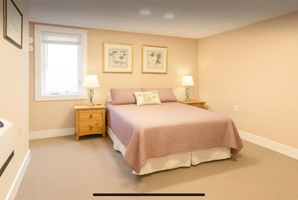 a bedroom with a bed and two lamps and a window at This Old Frat House Boutique Guest in Missoula