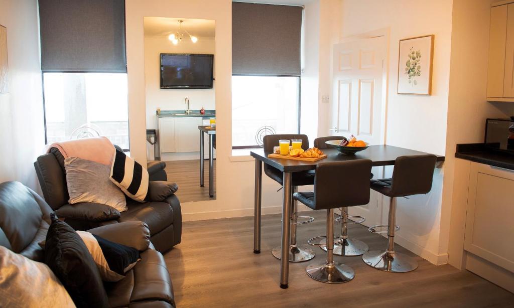 a living room with a couch and a table at Rook View in Buckie