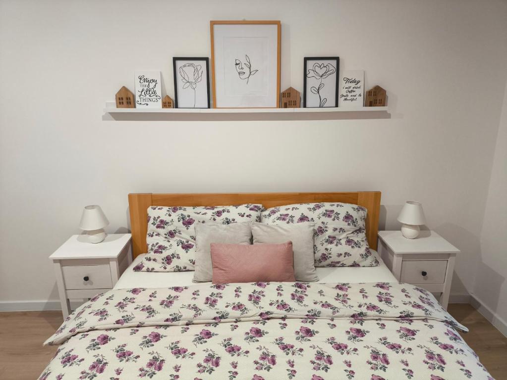 a bedroom with a bed with two night stands and two lamps at Apartman Ema in Donovaly