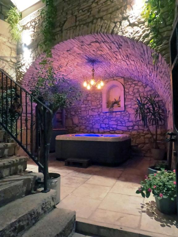 a room with a bath tub in a stone wall at Stone House Hedonia in Blato