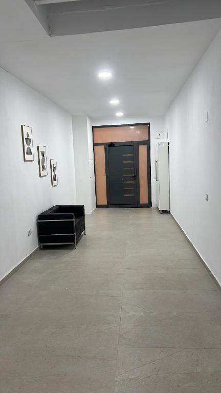 a large room with a hallway with a black door at Apartamento en el centro vinaros in Vinarós