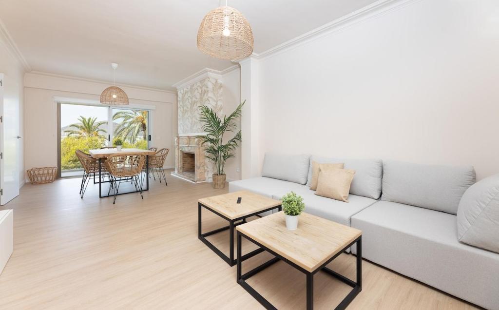 a living room with a white couch and a table at Mar Blau in Port d'Alcudia