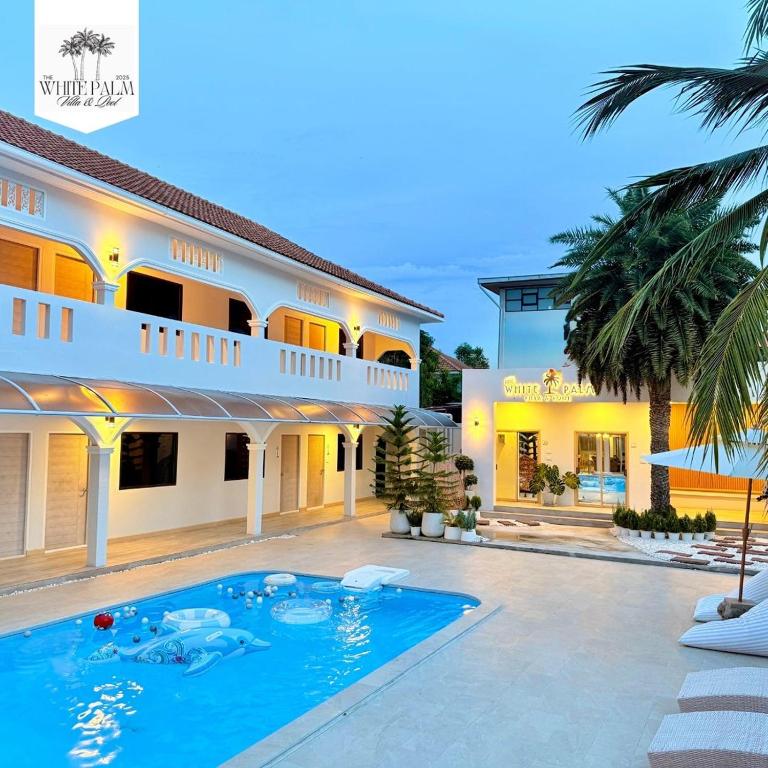 a house with a swimming pool in front of it at The White Palm Villa & Pool in Khon Kaen