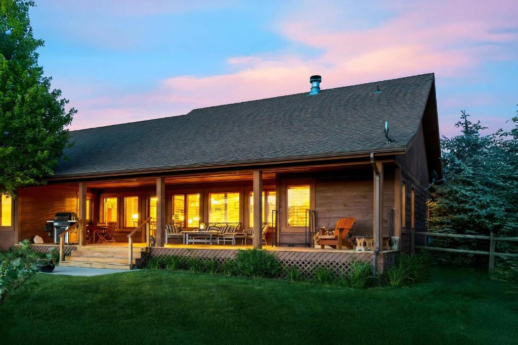 a home with a large deck and a house at Upscale Hot Tub Wildlife Views in Victor