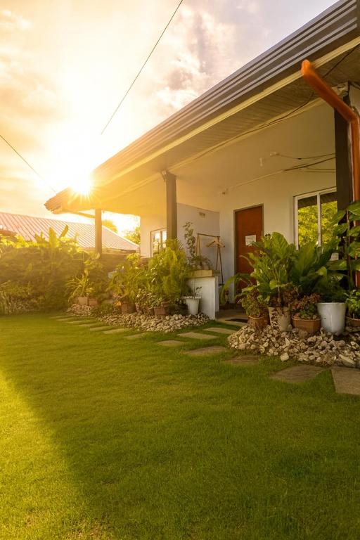 a house with a green lawn in front of it at Loft Baler with Kitchen & Ideal for Work from Home Setup in Baler