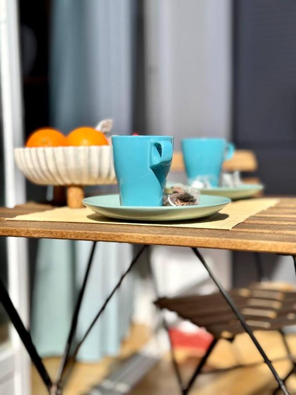 a table with two blue cups and plates on it at NextGen Casa Ilma in Antigua