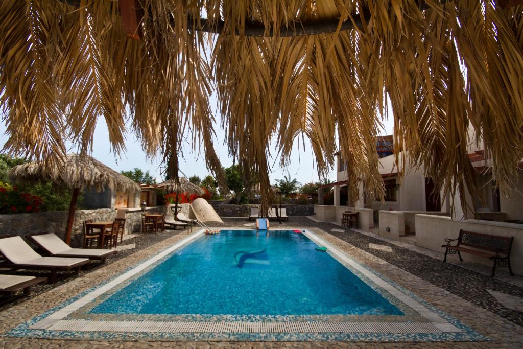 The swimming pool at or close to Birds Villa Apartments - Including Car Rental