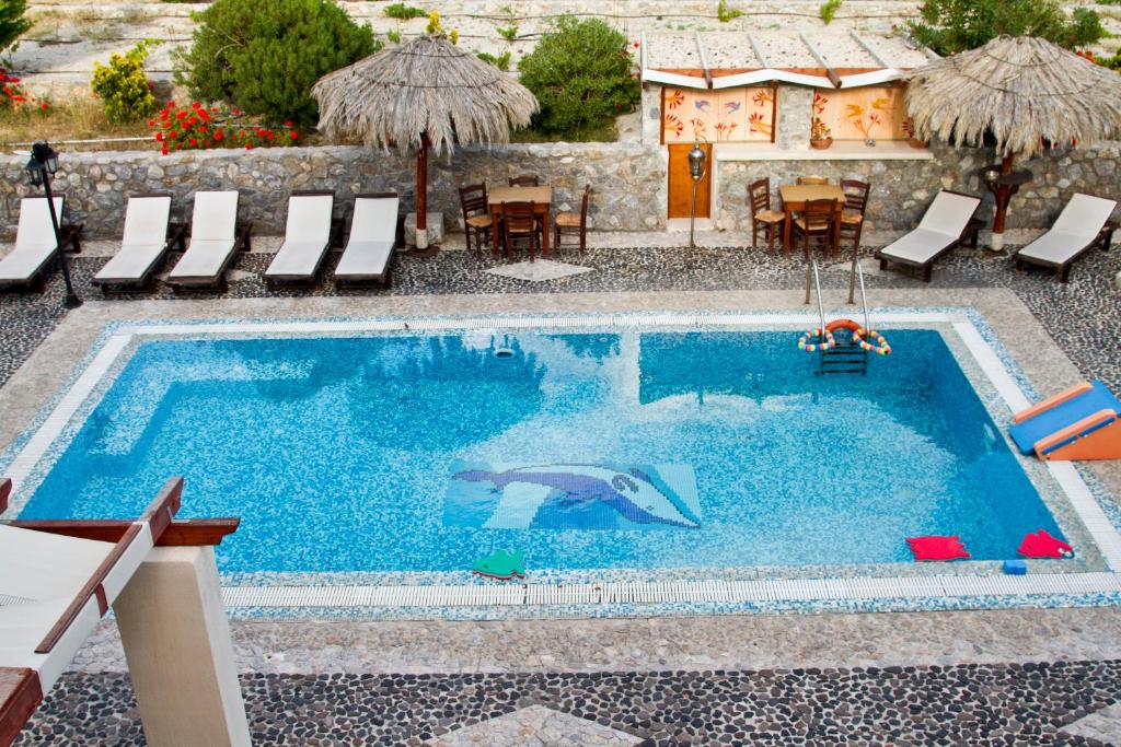 The swimming pool at or close to Birds Villa Apartments - Including Car Rental