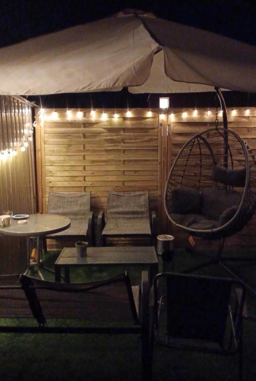 a room with a tent with chairs and a swing at Second&Home in Przeźmierowo
